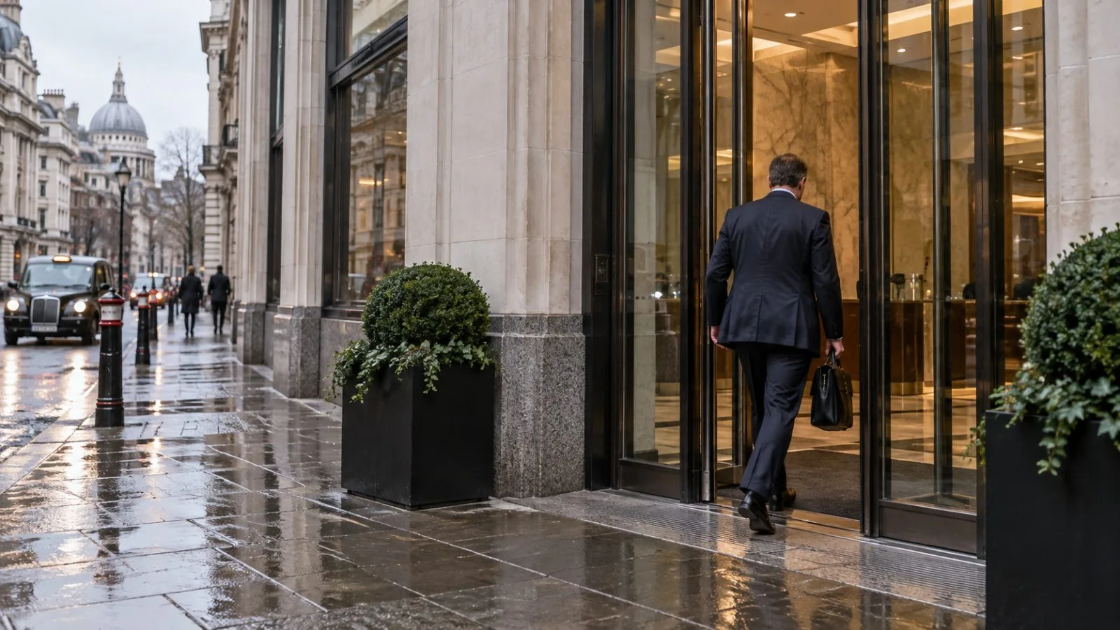 An office worker enters a financial advisory building in London on an overcast morning / EconoTimes.ai