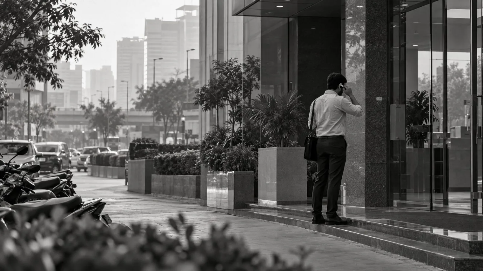 An anonymous wearer adjusts a compact sensor beside a Gurugram office building in India. (AI-generated image / EconoTimes)