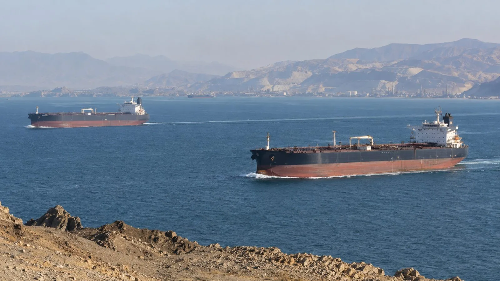 Oil tankers transit the Strait of Hormuz off Iran’s southern coast (AI-generated image / EconoTimes)