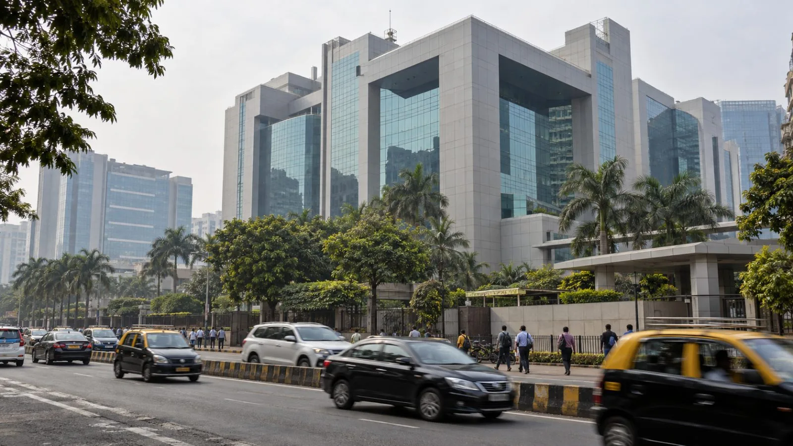 Employees walk past an office building at Tech Mahindra's Hinjawadi campus in Pune. / EconoTimes.ai