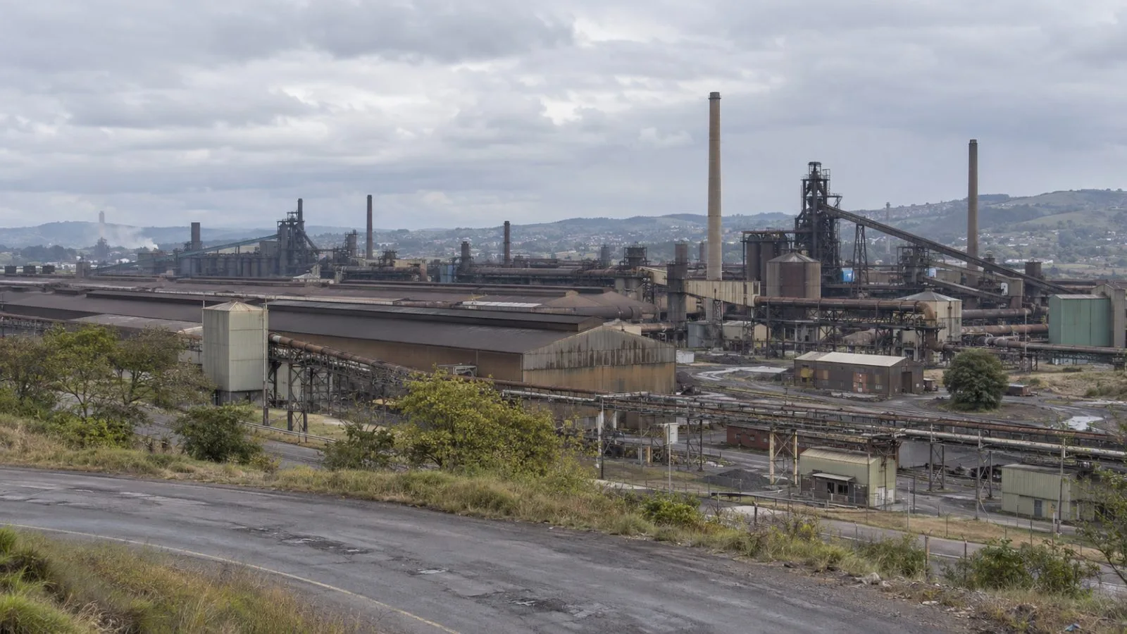 Steelworks buildings stand at the Newcastle plant in KwaZulu-Natal, South Africa. (AI-generated image / EconoTimes)