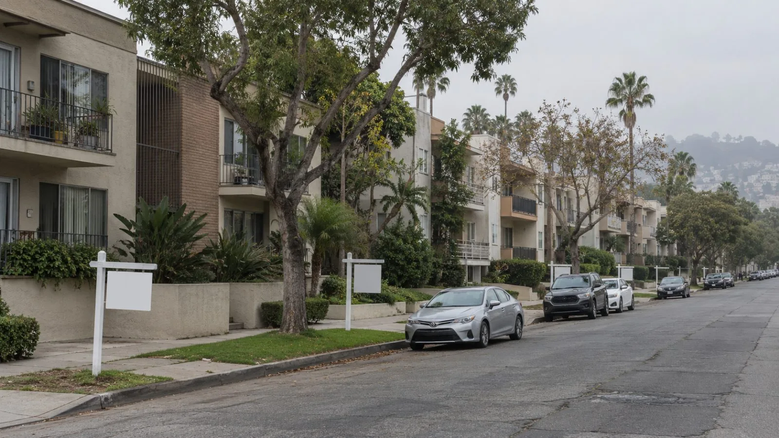 For-sale signs stand outside condominiums on a residential street in Los Angeles, California. (AI-generated image / EconoTimes)
