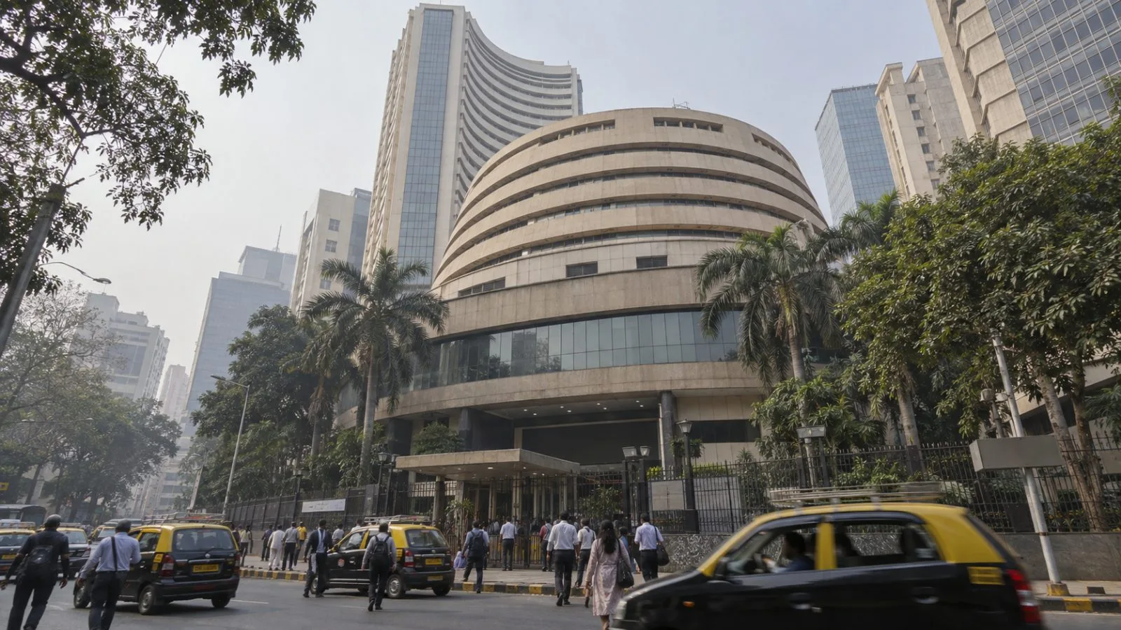 Pedestrians pass the Bombay Stock Exchange building in Mumbai's Fort district / EconoTimes.ai
