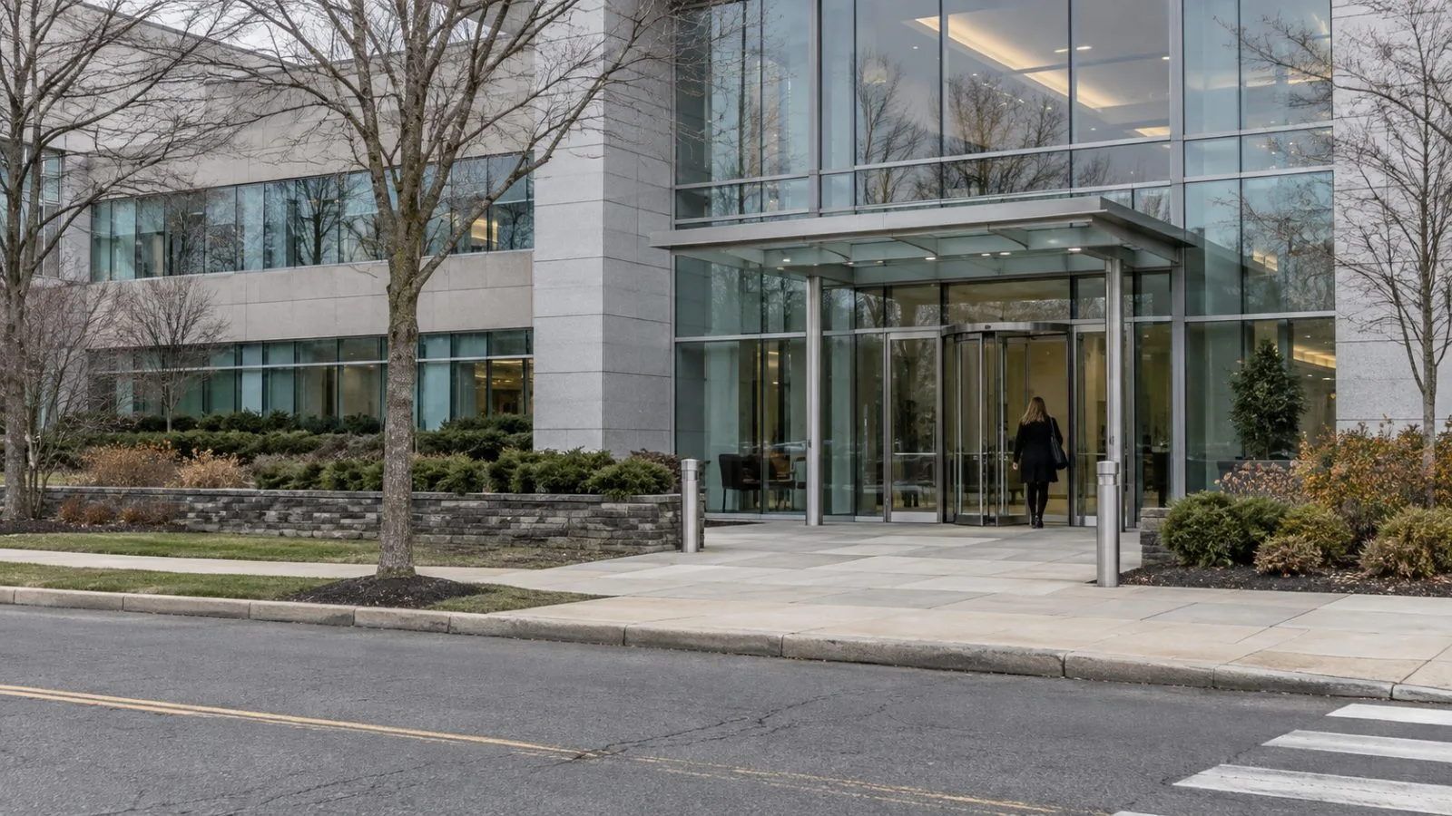 An employee enters the office building at EMCOR Group’s headquarters in Norwalk, Connecticut. (AI-generated image / EconoTimes)