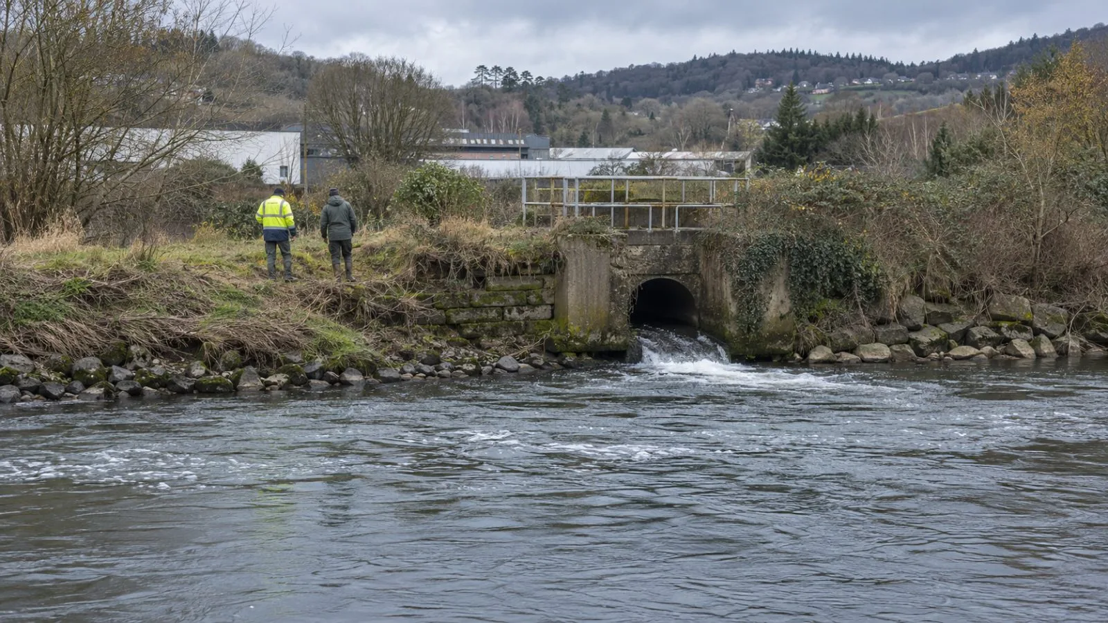 Workers inspect the River Taff beside a drainage culvert near Nantgarw, Wales, as cleanup continues. (AI-generated image / EconoTimes)