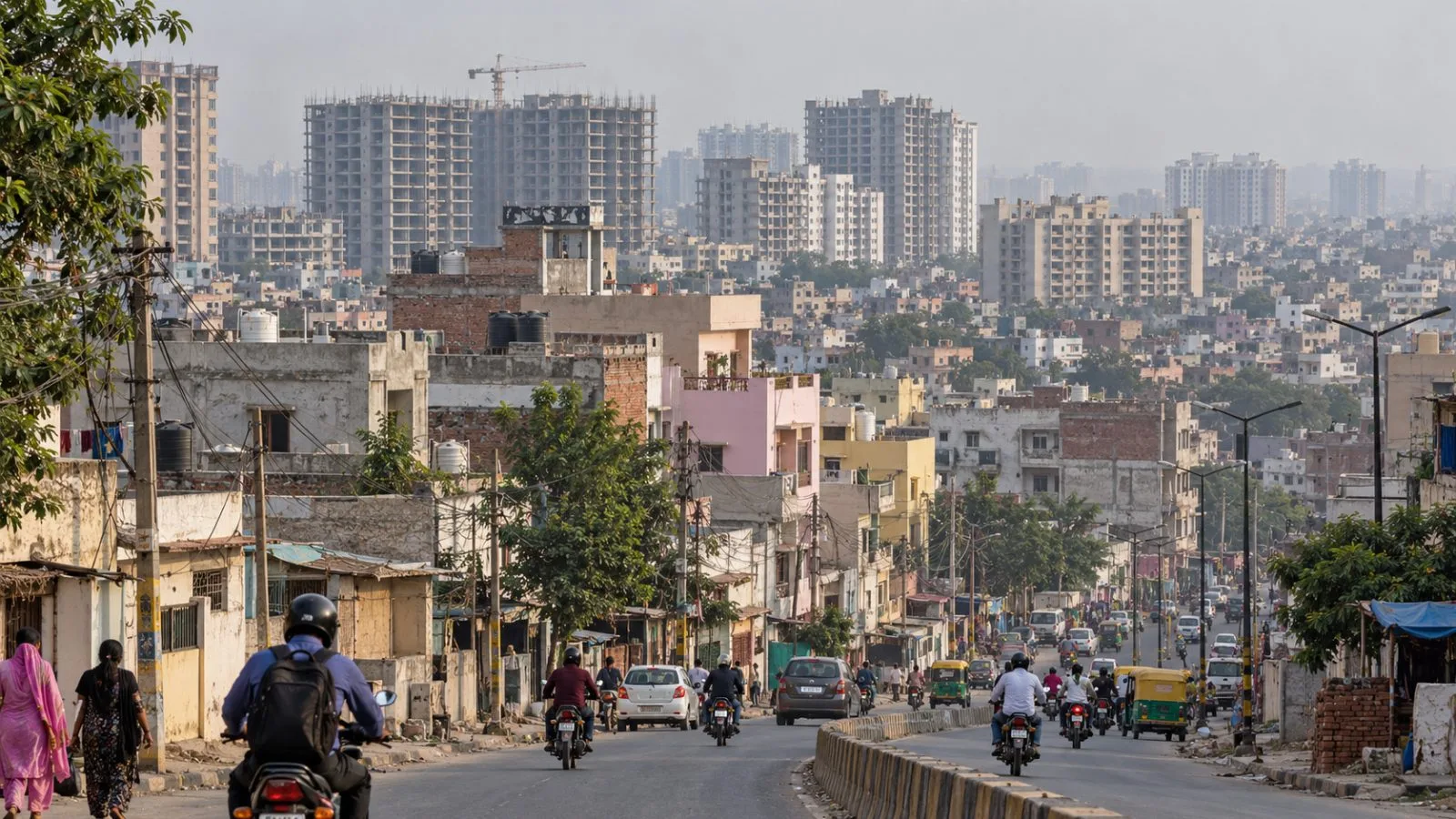 New apartment blocks rise above a dense residential district on Ghaziabad’s urban edge, India. (AI-generated image / EconoTimes)