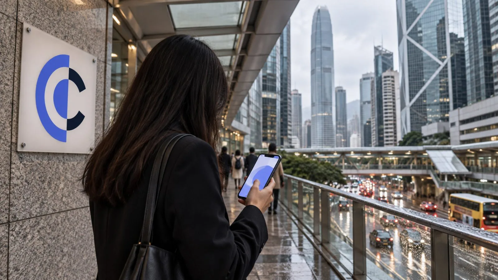 A pedestrian checks a smartphone on a covered walkway in Hong Kong’s Central district. / EconoTimes.ai