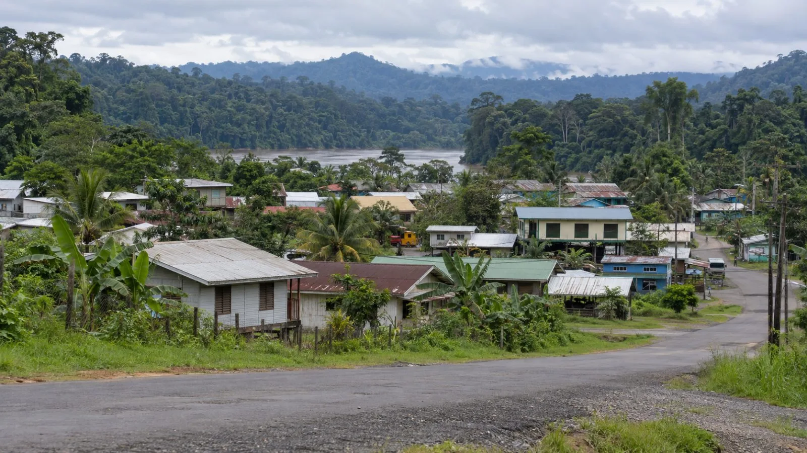 Low-rise buildings sit beside dense tropical forest in Kiunga, Papua New Guinea. (AI-generated image / EconoTimes)