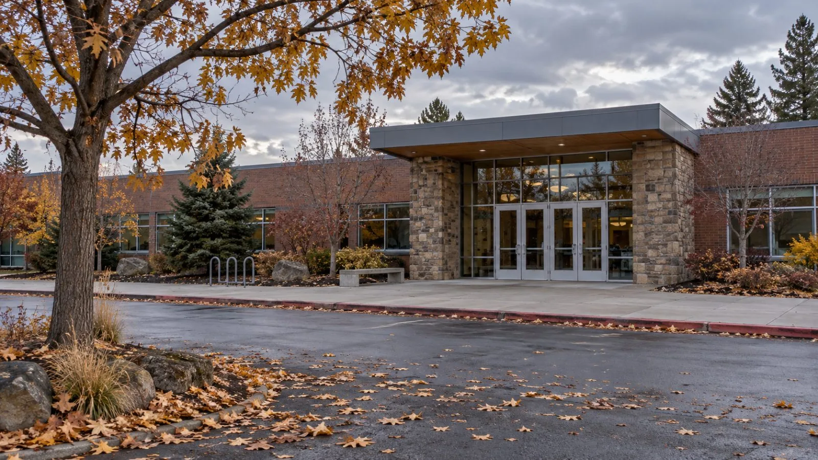 The glass entrance of Silver Rail Elementary School faces a quiet street in Bend, Oregon. (AI-generated image / EconoTimes)