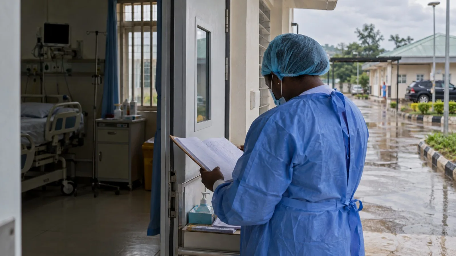 A health worker reviews a tracing register at a clinic in Abuja, Nigeria. (AI-generated image / EconoTimes)