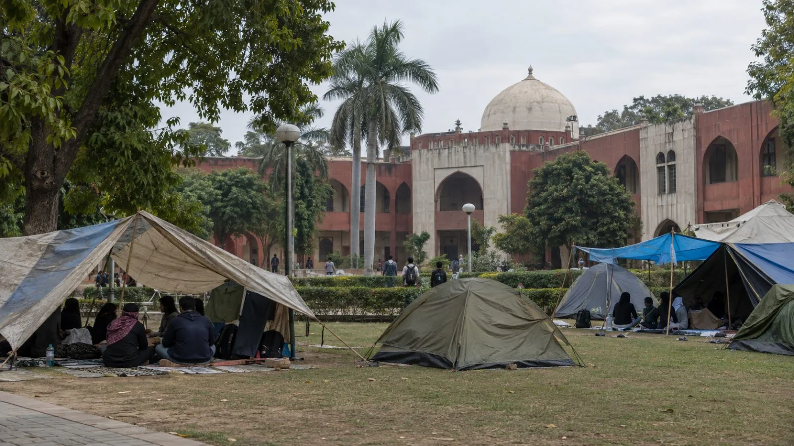 Protest tents stand on Jamia Millia Islamia’s campus in New Delhi as students continue their sit-in. (AI-generated image / EconoTimes)
