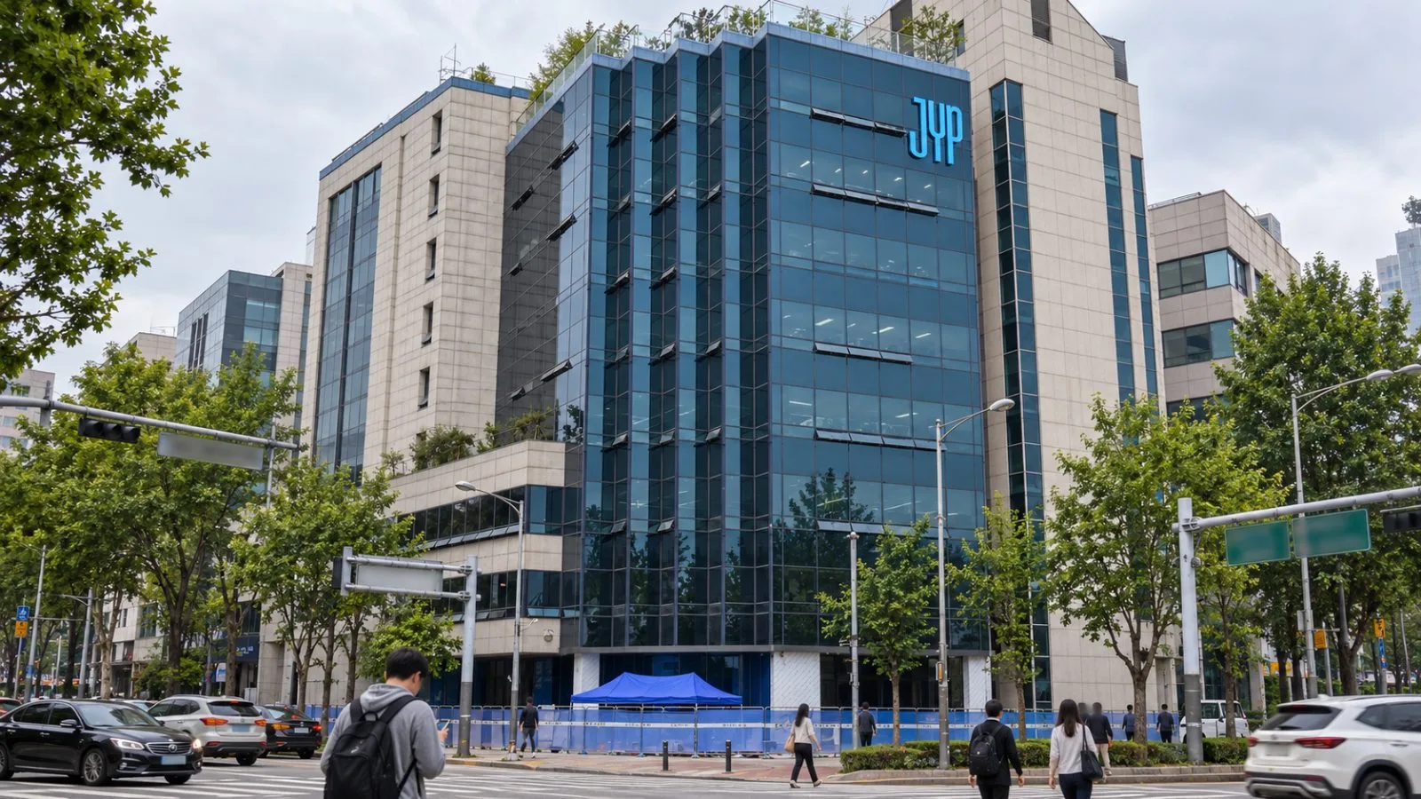 Pedestrians pass the headquarters of JYP Entertainment in Seoul, South Korea. / EconoTimes.ai