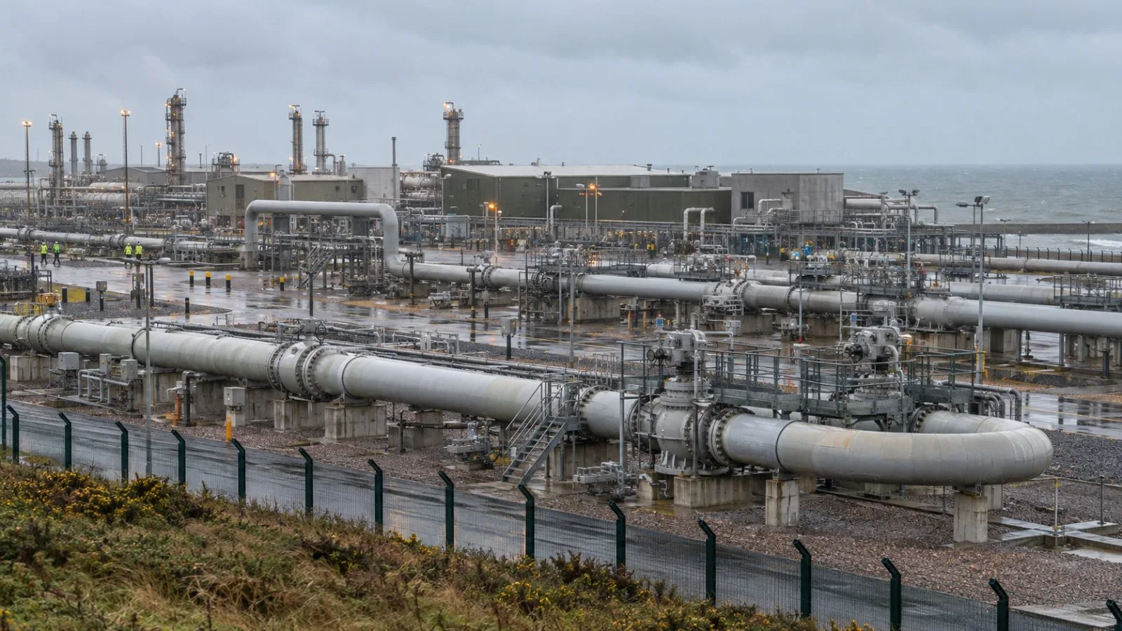 Gas pipelines and valve assemblies stand at the Bacton terminal in Norfolk, England. (AI-generated image / EconoTimes)