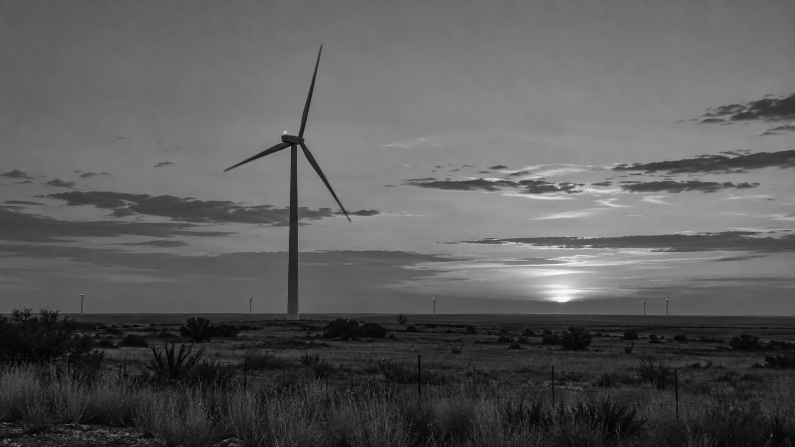 Wind turbines turn above dry grassland near Sweetwater, Texas, in fading evening light. (AI-generated image / EconoTimes)