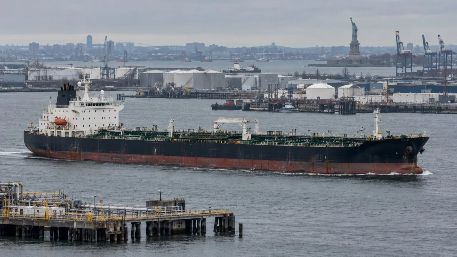A product tanker passes harbor terminals in New York under a gray morning sky. (AI-generated image / EconoTimes)