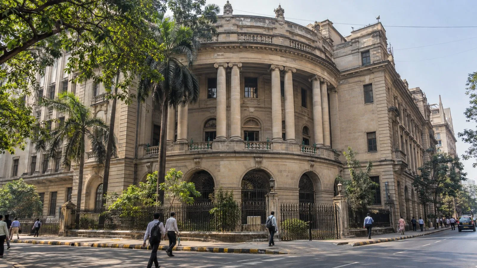 Pedestrians pass the Bombay Stock Exchange building in Mumbai’s Fort district under a hazy morning sky (AI-generated image / EconoTimes)