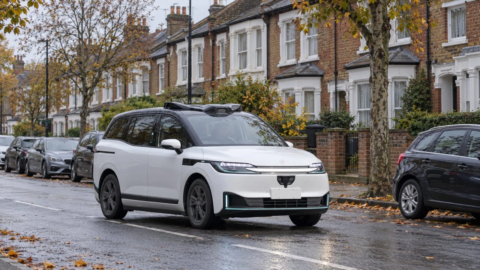 A robotaxi test vehicle travels along a residential street in Brent, north-west London. / EconoTimes.ai