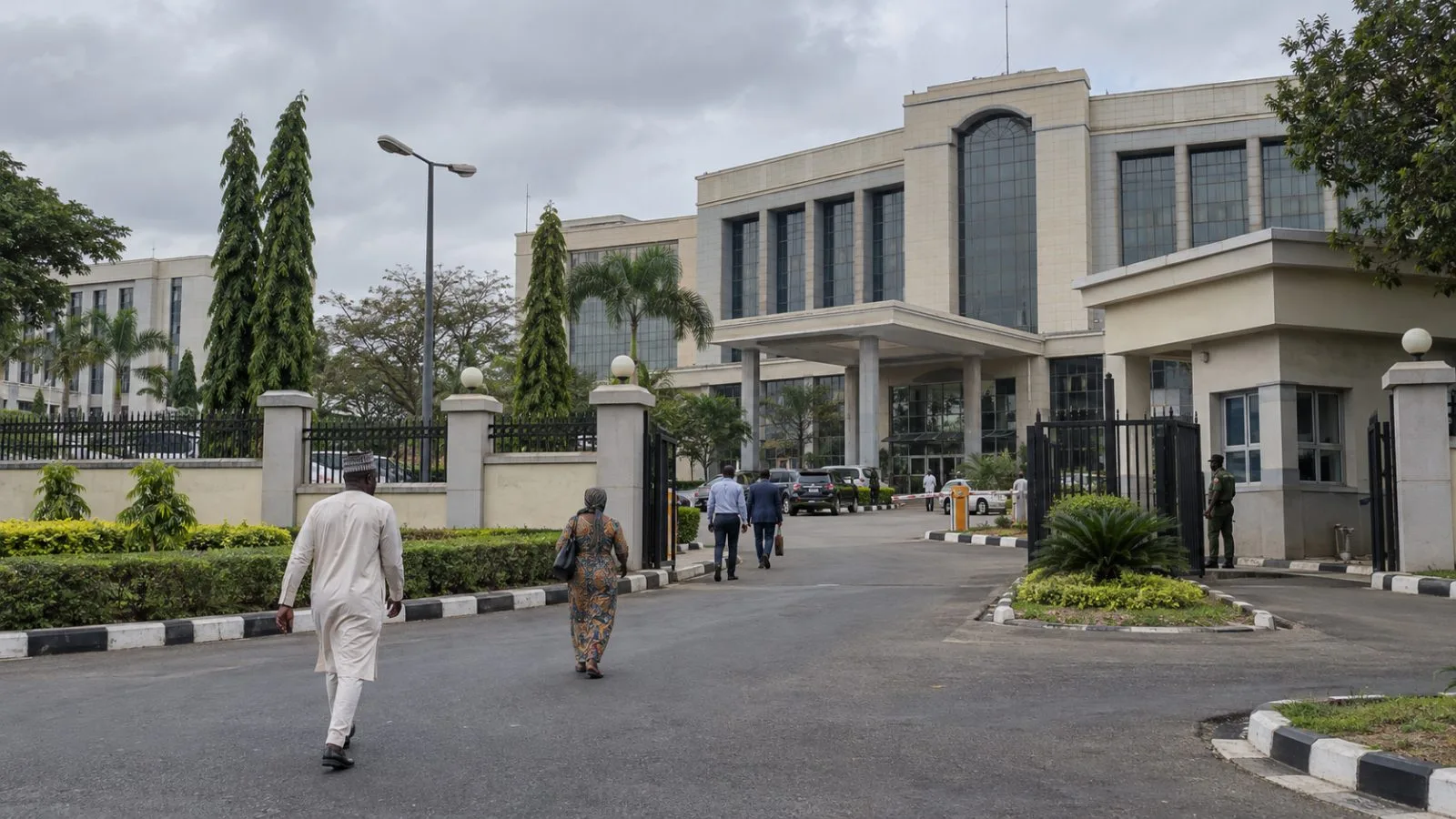 Pedestrians pass a federal government office building in Abuja, Nigeria. (AI-generated image / EconoTimes)