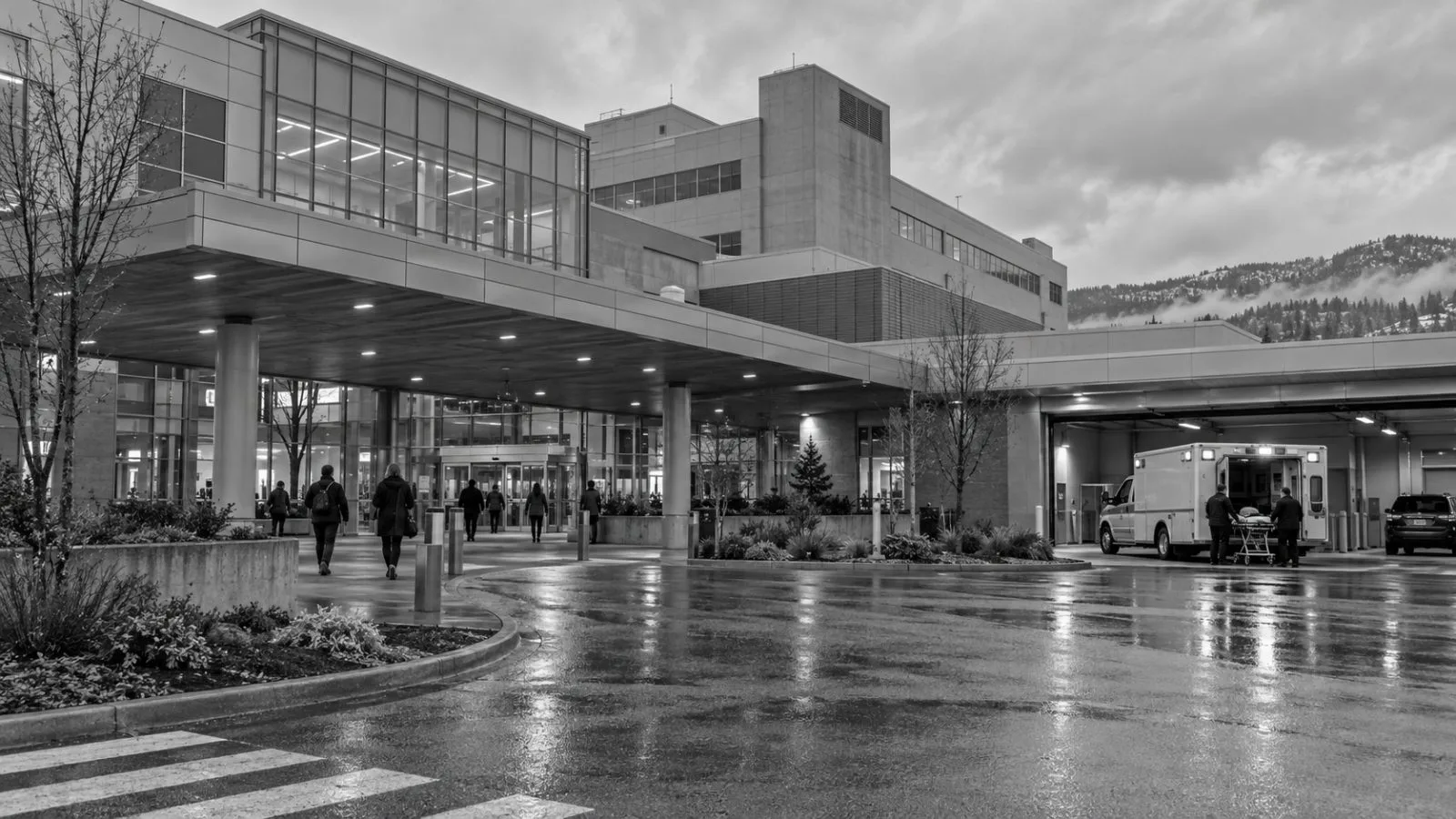 Visitors enter Kelowna General Hospital in Kelowna, British Columbia, beneath an overcast sky. (AI-generated image / EconoTimes)