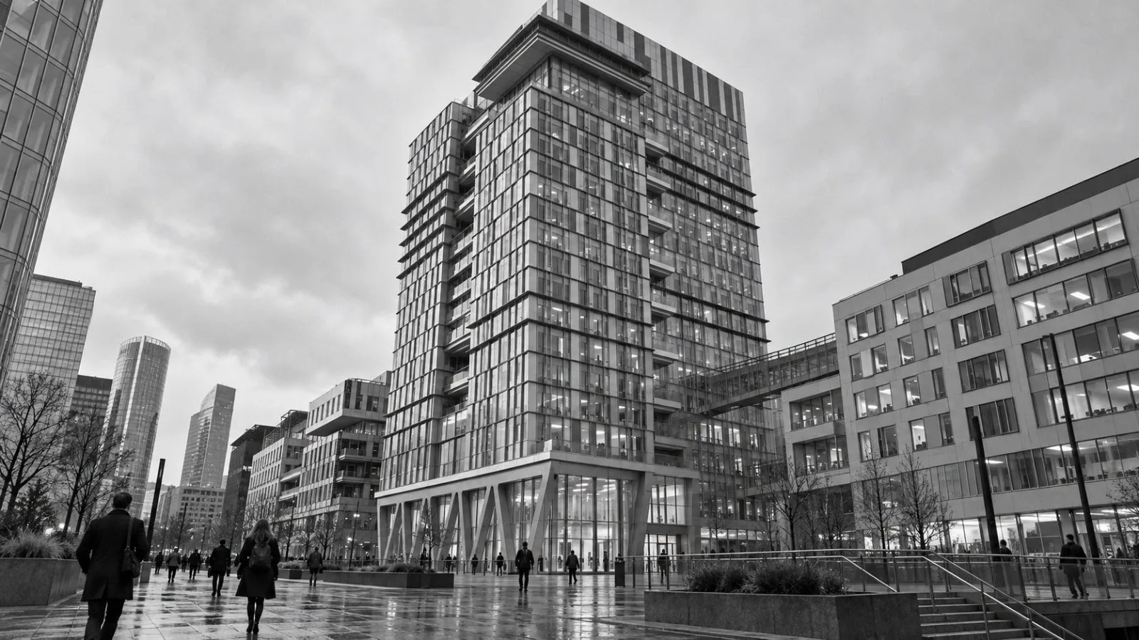 Pedestrians pass the entrance to VINCI’s headquarters in Nanterre, France, under overcast skies. / EconoTimes.ai
