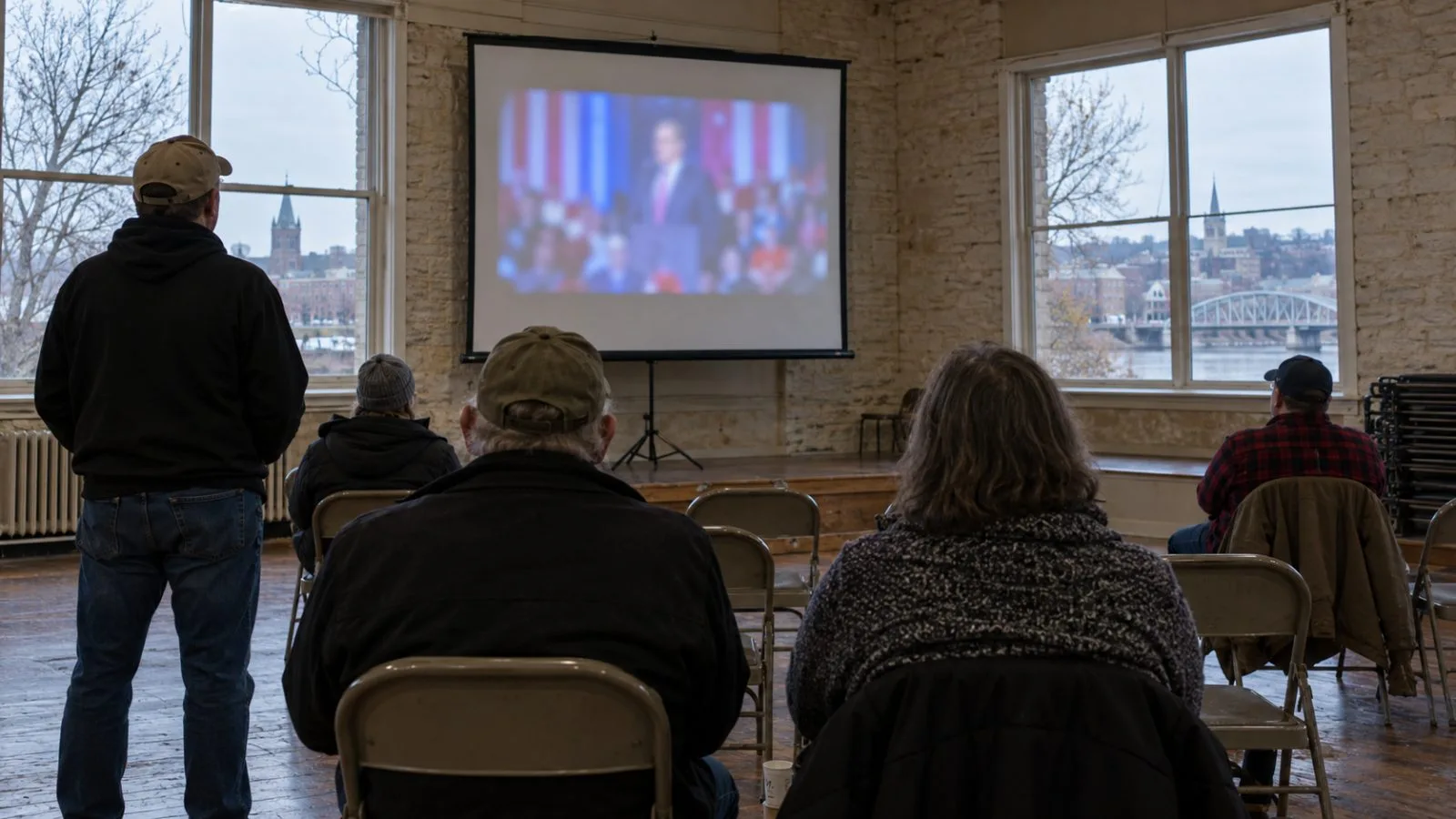 Voters watch a remote campaign rally in a community hall in Dubuque, Iowa. (AI-generated image / EconoTimes)
