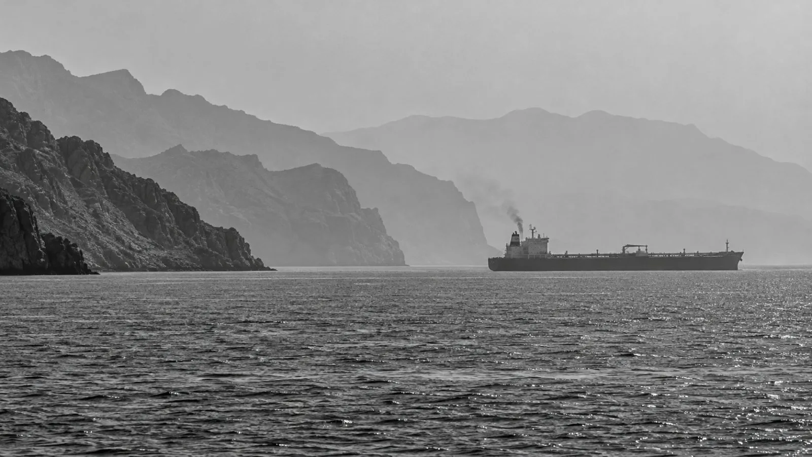 A commercial tanker transits the waters east of the Strait of Hormuz off Bandar Abbas, Iran / EconoTimes.ai (mono)