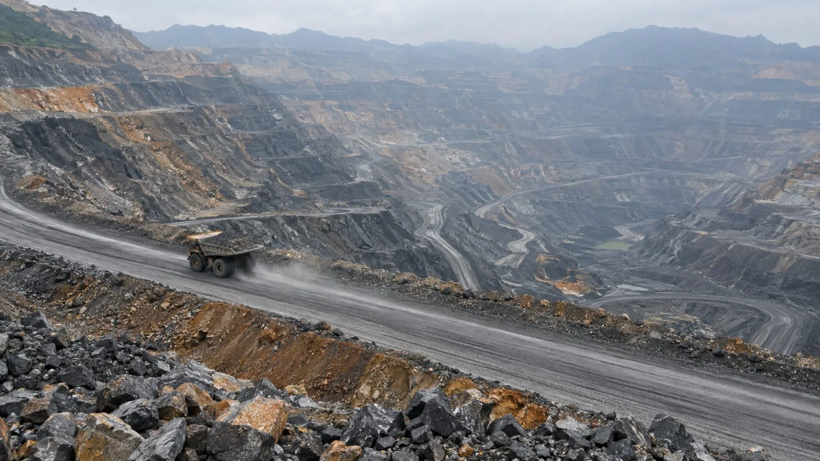 A coal haul truck crosses a terraced bench at Cao Son mine in Quang Ninh, Vietnam. (AI-generated image / EconoTimes)
