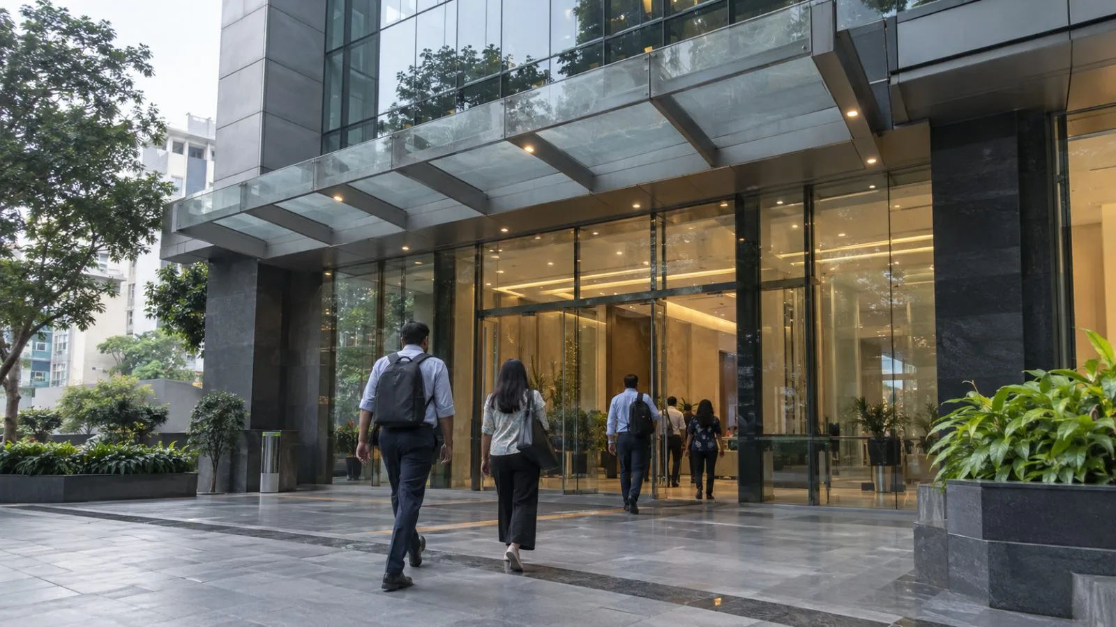 Office workers enter the Ascent Building in Bengaluru’s Koramangala district, India. (AI-generated image / EconoTimes)