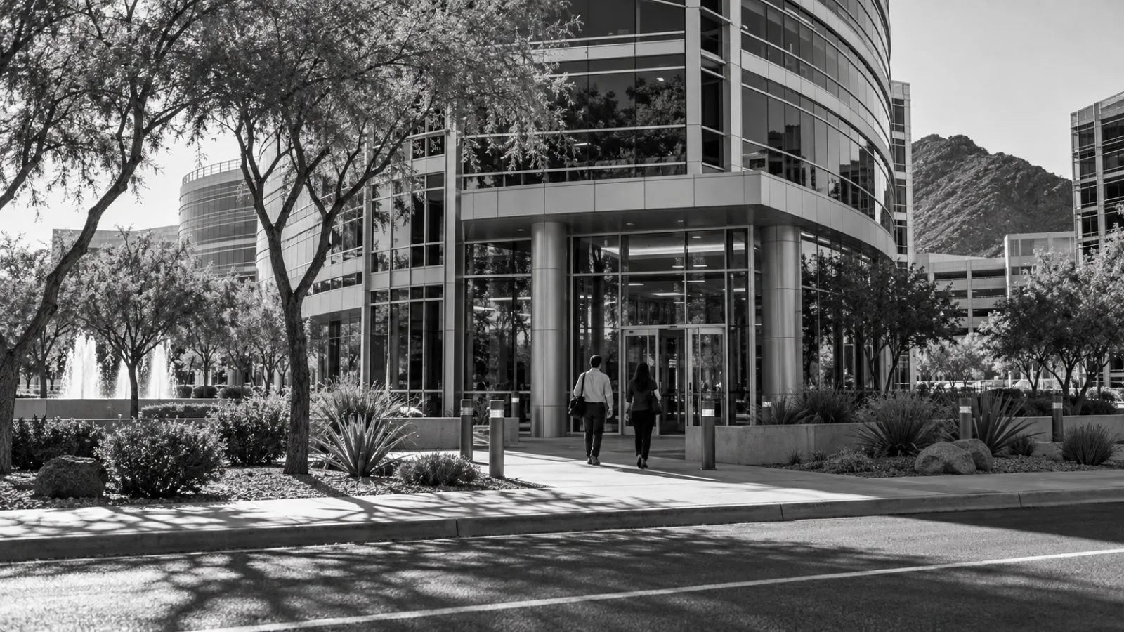 Employees enter an office building on Rio Salado Parkway in Tempe, Arizona. / EconoTimes.ai
