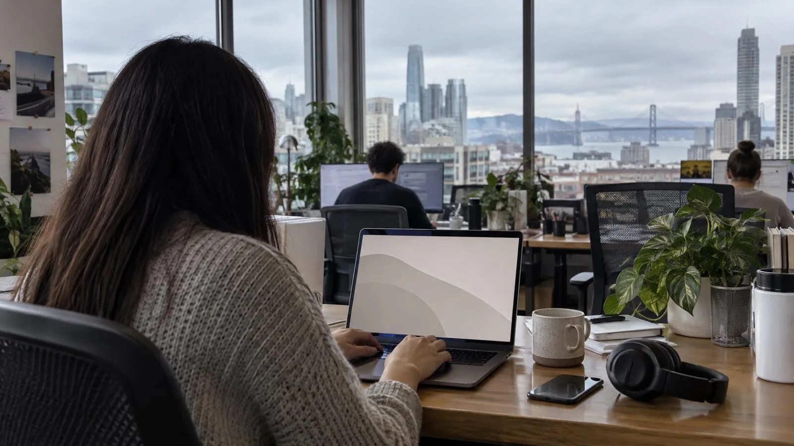 Anonymous hands type into a laptop browser assistant at a San Francisco technology office. (AI-generated image / EconoTimes)
