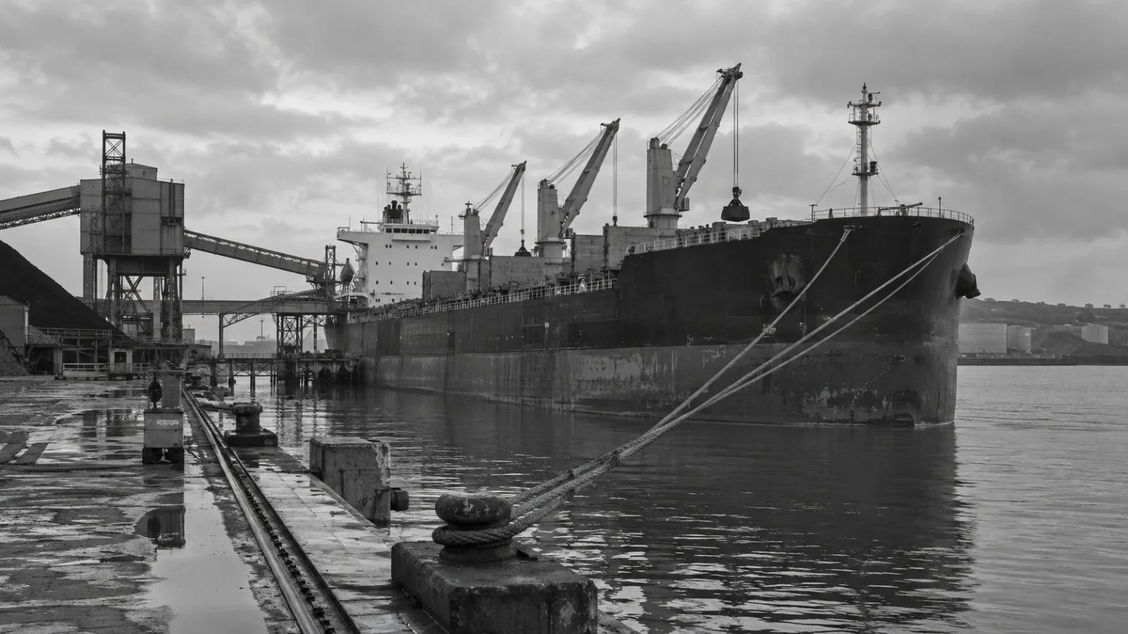 A cargo vessel sits alongside the working quay at Milford Haven, Wales. (AI-generated image / EconoTimes)