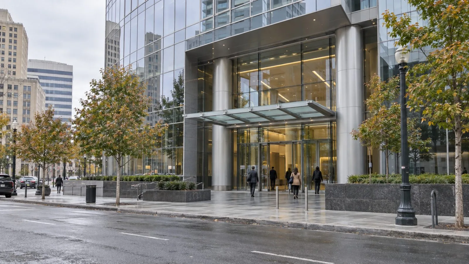 Pedestrians pass a corporate headquarters in Oakland’s City Center district, California. / EconoTimes.ai
