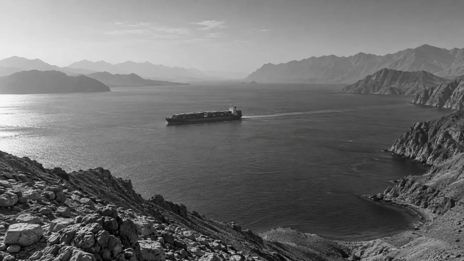 A container ship crosses the Strait of Hormuz near Khasab, Oman. (AI-generated image / EconoTimes)