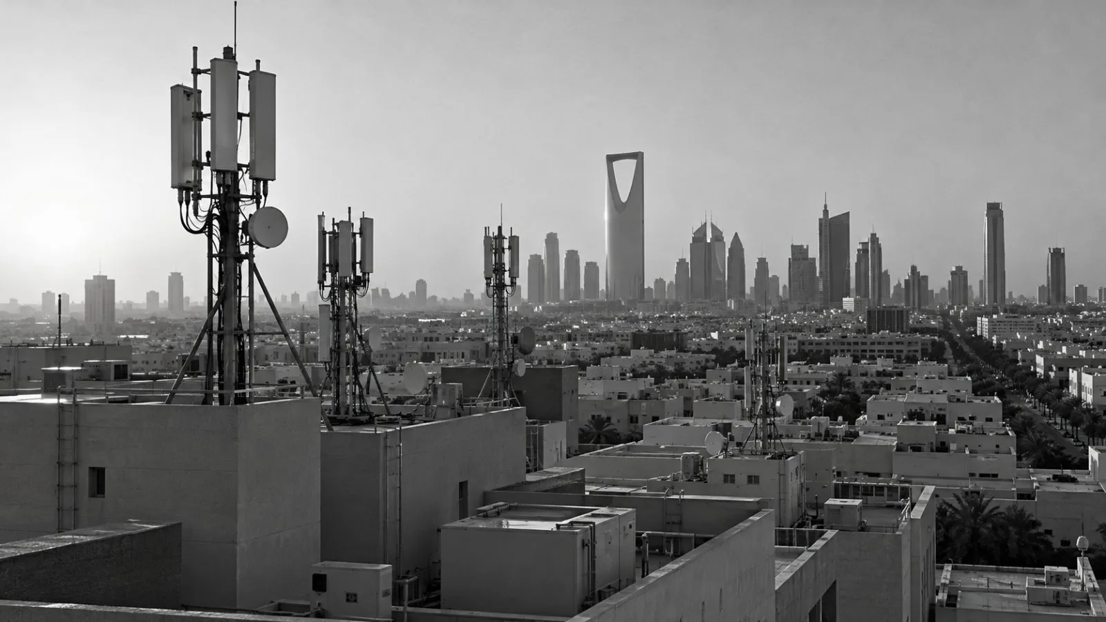 Cellular antennas stand above rooftops in Riyadh, Saudi Arabia, in afternoon sunlight. (AI-generated image / EconoTimes)