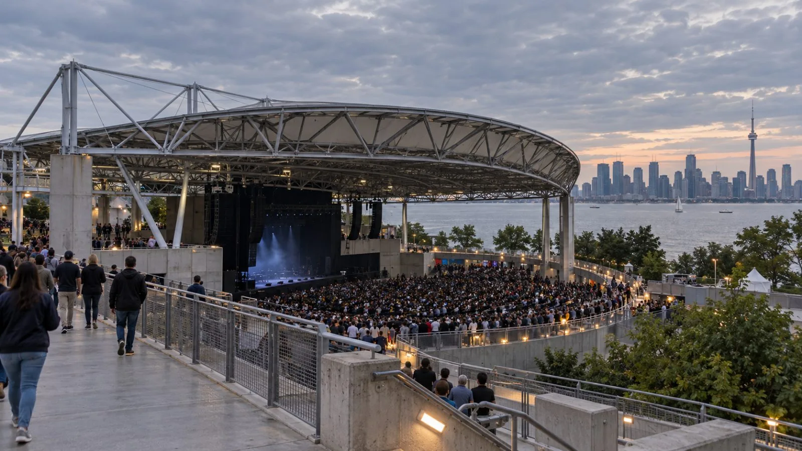 The open-air RBC Amphitheatre sits beside Lake Ontario in Toronto under an overcast summer sky. / EconoTimes.ai