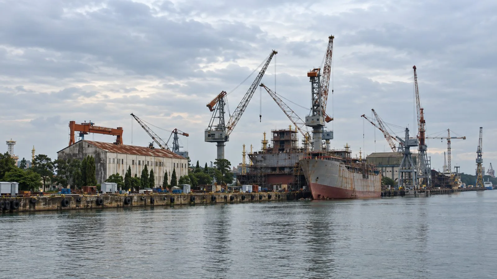 A partly built vessel rests in a dry dock at Cochin Shipyard in Kochi, India. / EconoTimes.ai