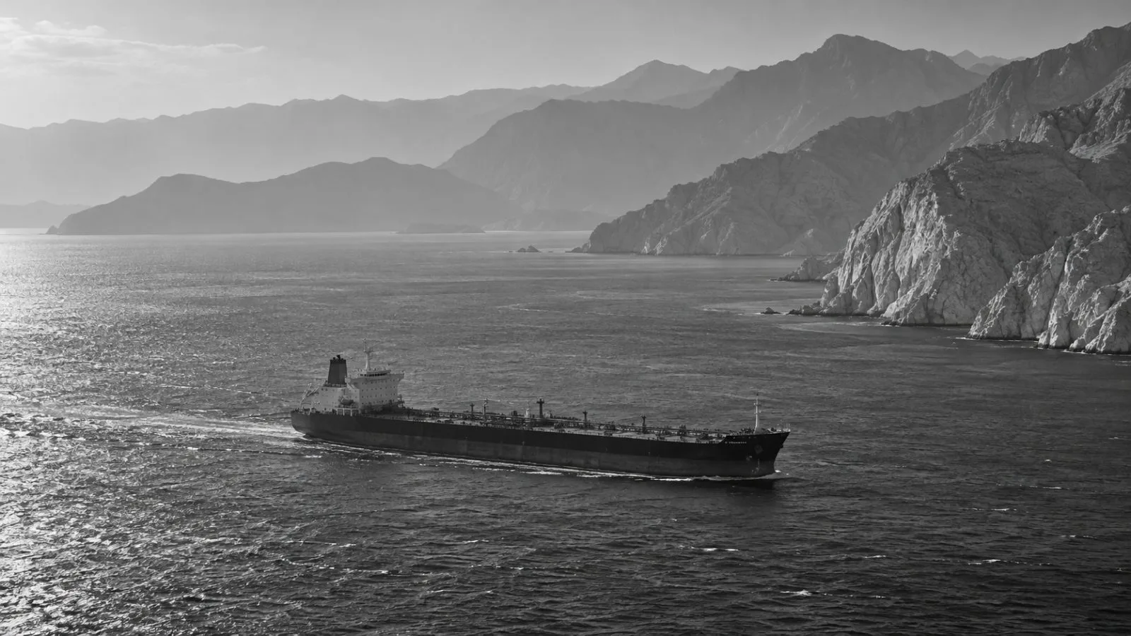A merchant vessel crosses the Strait of Hormuz near Khasab, Oman (AI-generated image / EconoTimes)