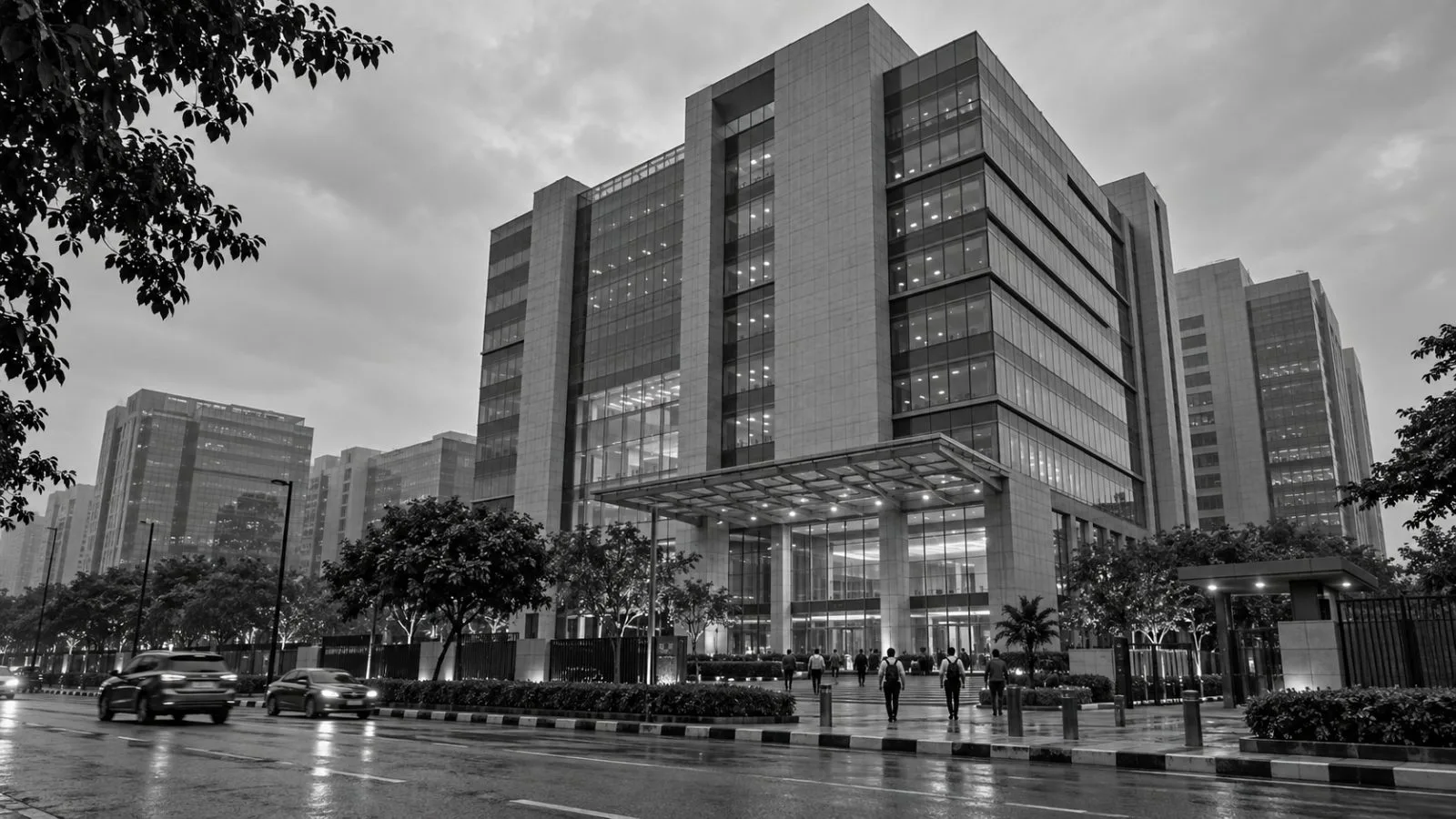 Employees arrive at the One Skymark Tower D office complex in Noida, India. (AI-generated image / EconoTimes)