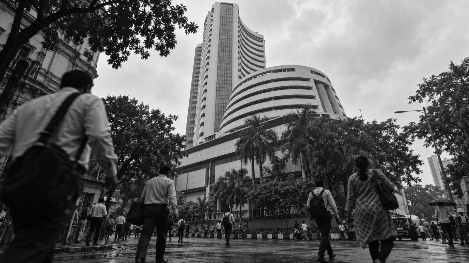 Pedestrians pass the BSE building on Dalal Street in Mumbai on an overcast morning. (AI-generated image / EconoTimes)