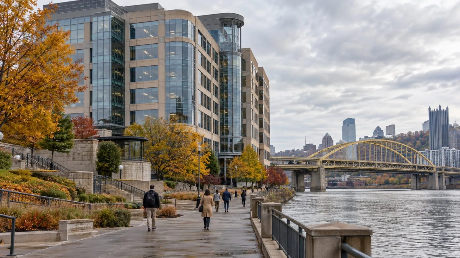 An office building stands along the Monongahela River in Pittsburgh, Pennsylvania, beneath autumn clouds. (AI-generated image / EconoTimes)