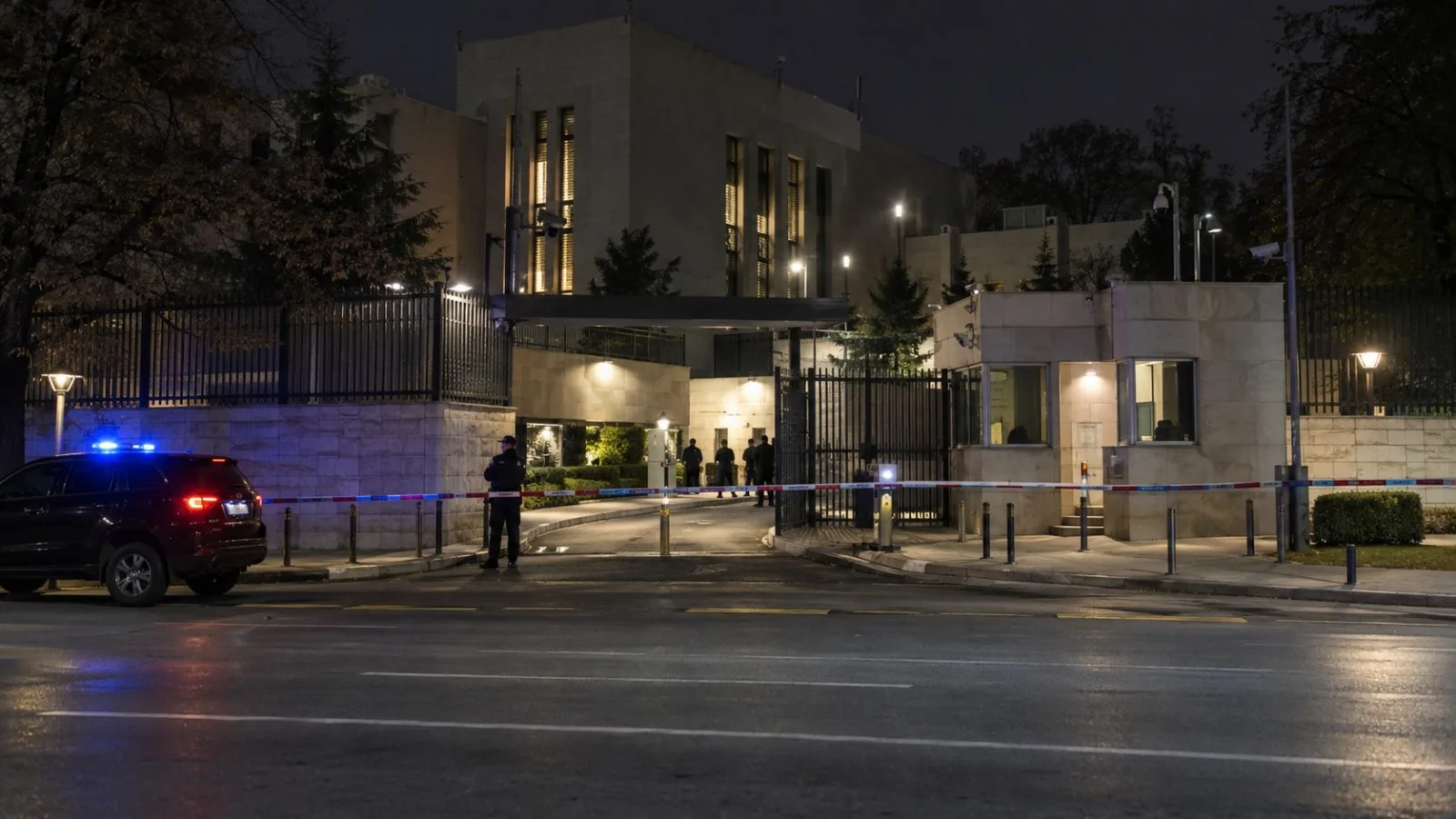 Police tape surrounds the guard booth outside Israel’s embassy in Belgrade at night. (AI-generated image / EconoTimes)