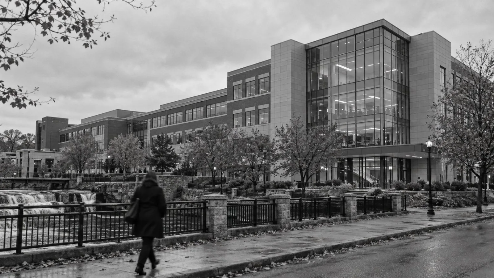 A pedestrian passes an office building in Woonsocket, Rhode Island, under overcast skies. (AI-generated image / EconoTimes)