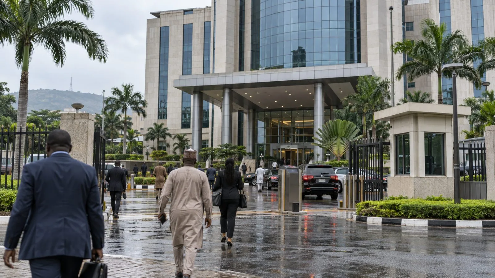 Commuters pass a government financial office in Abuja, Nigeria, beneath an overcast sky. (AI-generated image / EconoTimes)