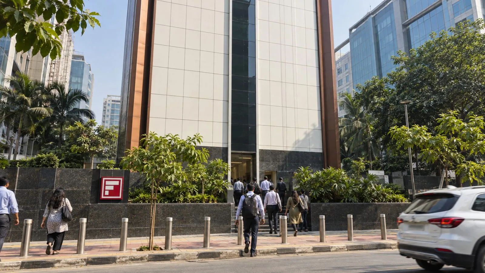 Customers enter a bank branch on a busy street in Mumbai, India. / EconoTimes.ai