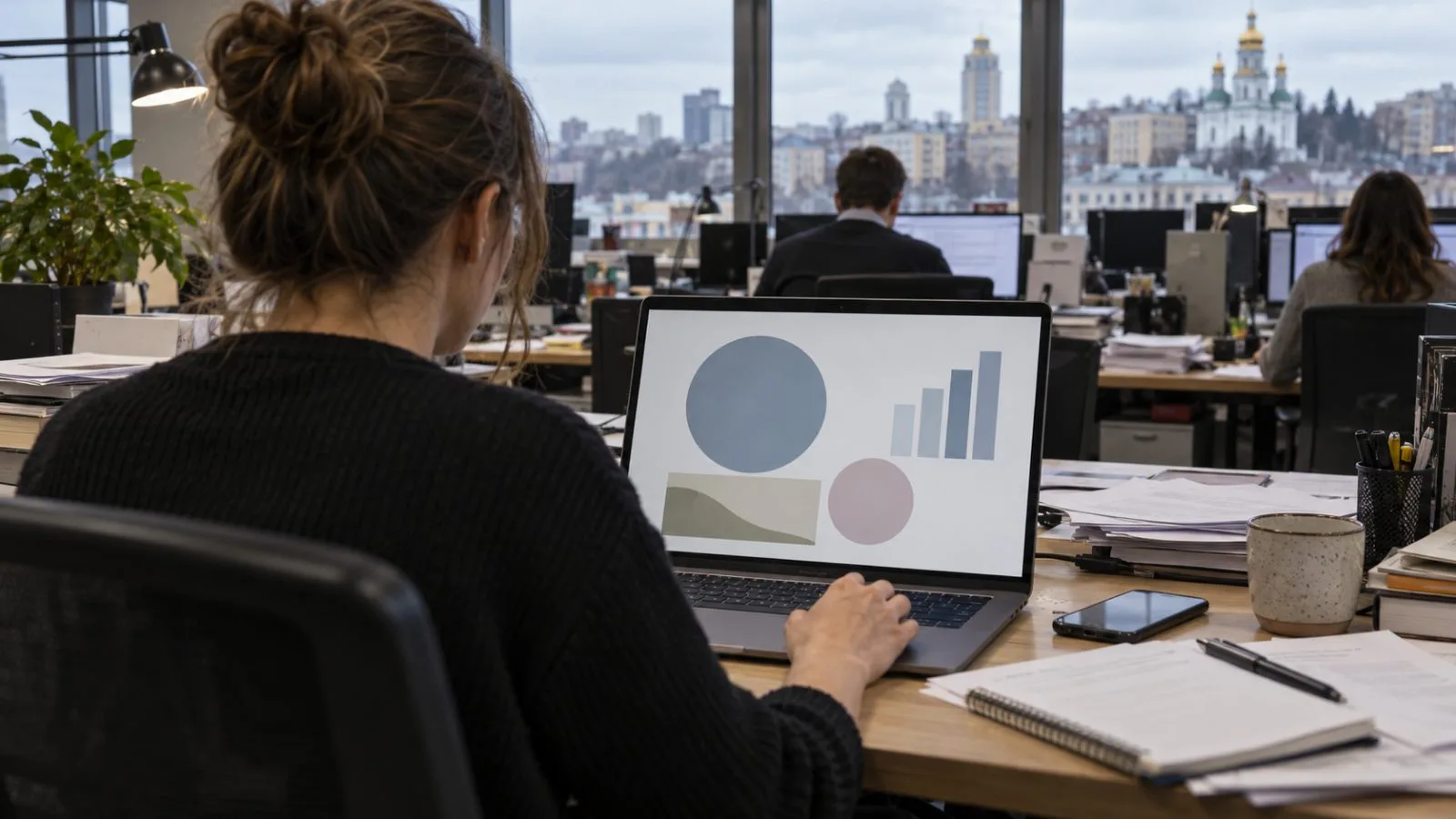 An editor reviews a missile component profile on a laptop in a Kyiv newsroom. (AI-generated image / EconoTimes)