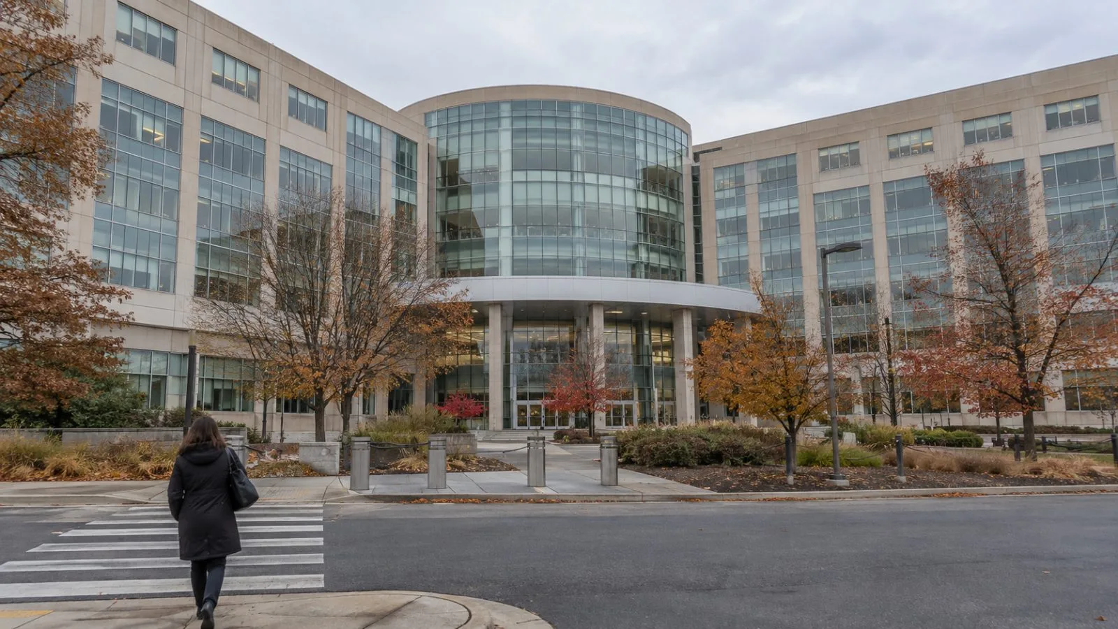 A pedestrian passes the Bureau of Economic Analysis building in Suitland, Maryland. (AI-generated image / EconoTimes)