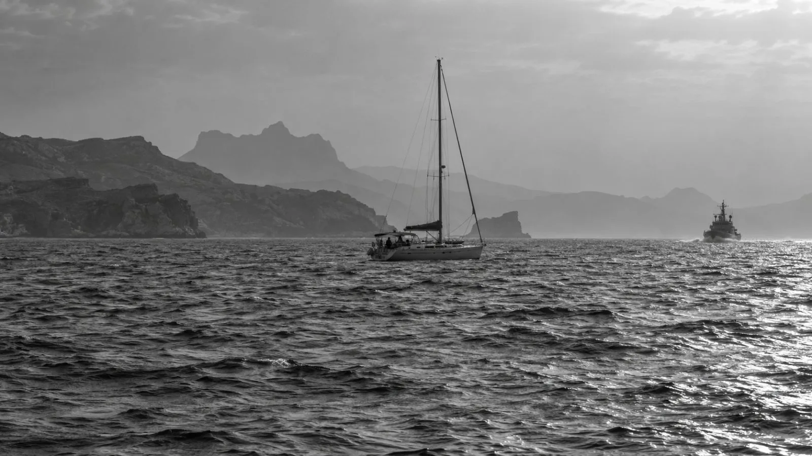 A small yacht sits offshore near Zuqar Island in Yemen under a hazy sky (AI-generated image / EconoTimes)