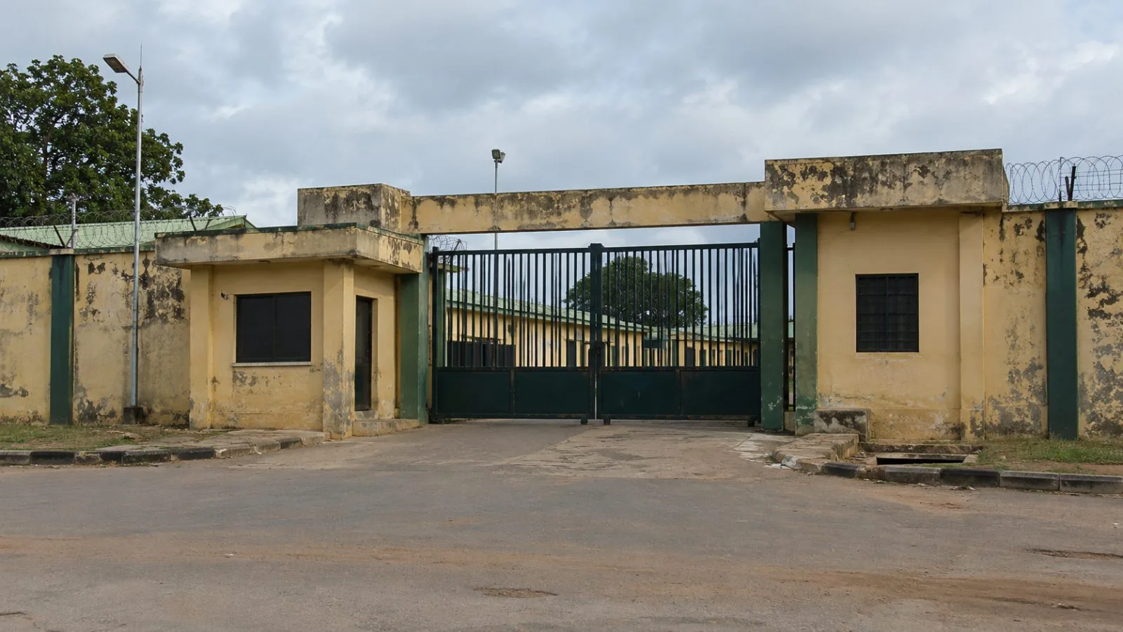 A barred entrance marks a detention facility in Minna, Niger State, Nigeria. (AI-generated image / EconoTimes)