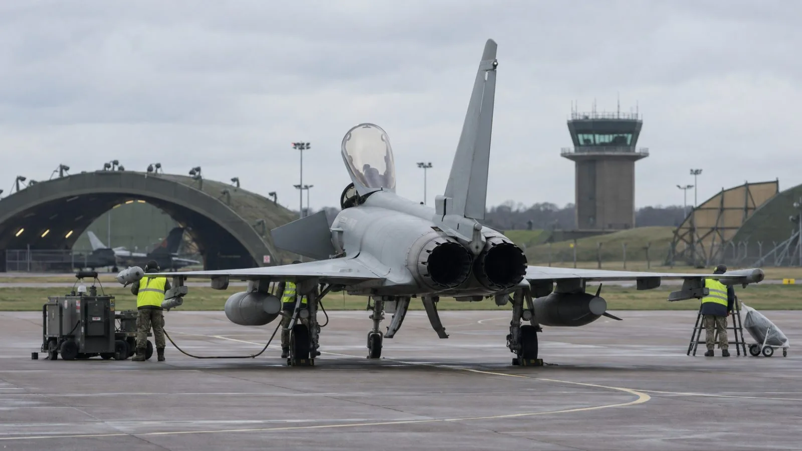 Ground crew work beside a Typhoon at RAF Coningsby near Lincoln, England. (AI-generated image / EconoTimes)