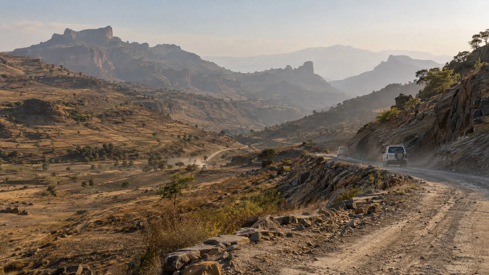 Vehicles travel a dusty road through the hills near Mirena in central Tigray. (AI-generated image / EconoTimes)